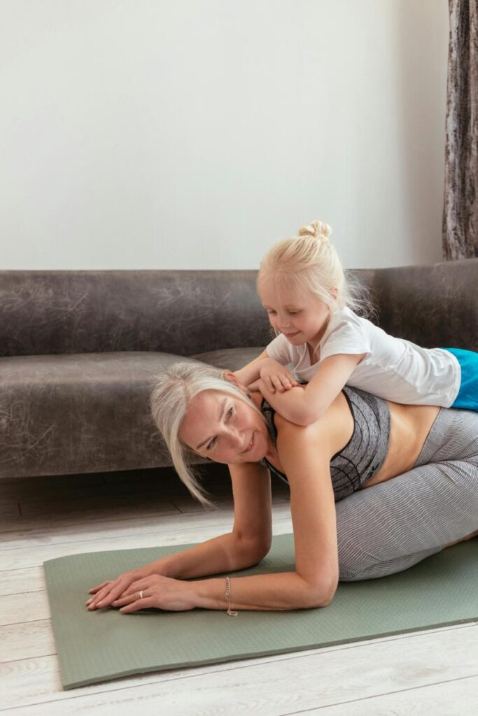 resident doing yoga with grandchild