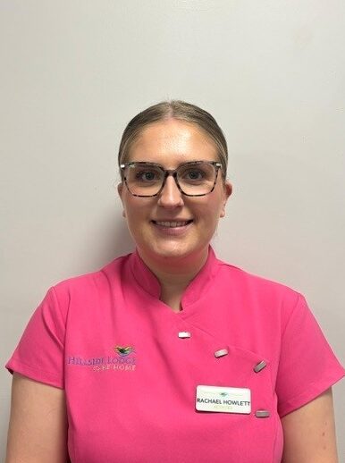 care home activities lead in pink uniform