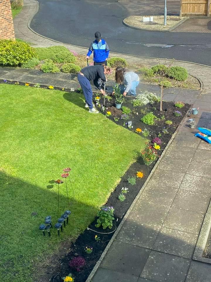 family gardening taken from second floor window