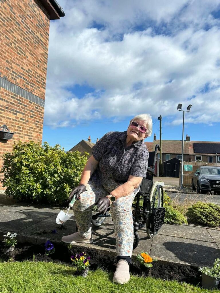 elderly resident gardening in her wheelchair