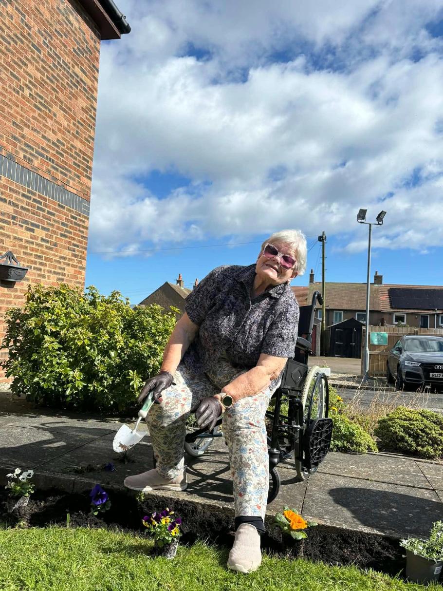 elderly resident gardening in her wheelchair
