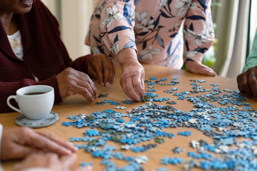 care home residents doing a jigsaw puzzle
